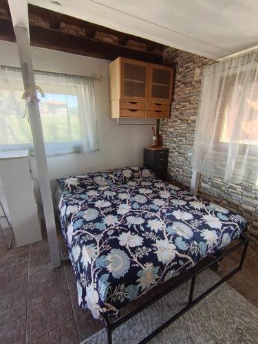 a bedroom with a bed in a room with windows at Villa Shiva Cerveteri, Casa Vacanze con SPA e Idromassaggio, Relax a due passi da Roma in Cerveteri