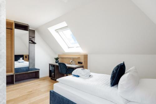 a bedroom with a white bed and a bathroom at Hotel Schloss Montabaur in Montabaur