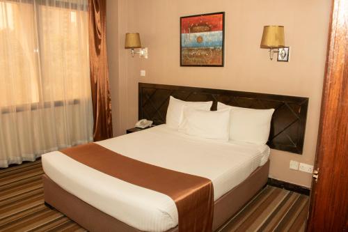 a bedroom with a bed in a hotel room at Clarion Hotel Nairobi in Nairobi