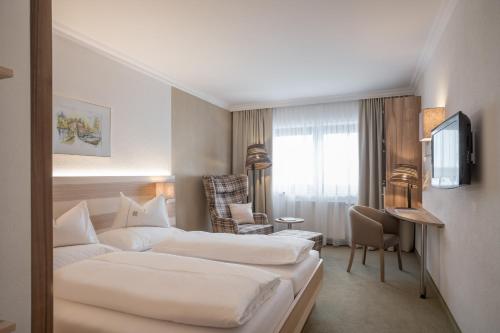 Postel nebo postele na pokoji v ubytování Hotel Madeleine