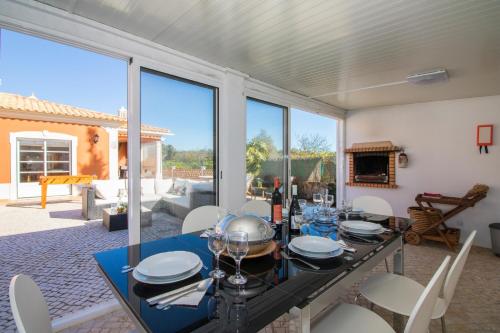 a dining room with a table and chairs at Quinta das Yuccas by Algarve Holidays in Boliqueime