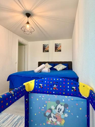 a bedroom with a mickey mouse bed with blue sheets at Luxuswohnung in Bodensee, im Radweg mit Parkplatz in Romanshorn