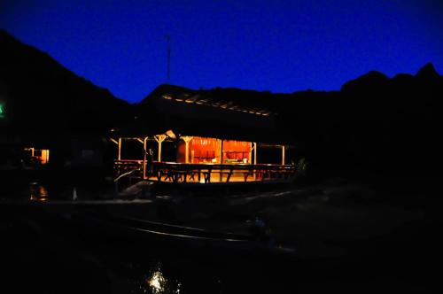 a house lit up at night with a blue at Lungcha Homestay in Sam Roi Yot