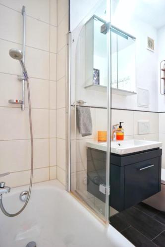 a bathroom with a shower and a sink at RELAX - ORANGE mit Pool und Sauna in Sonthofen