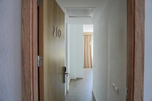 a hallway with a door to a room with a hallway at ENDLSS BEACH & DISCO HOTEL IBIZA Adults Only in San Antonio Bay