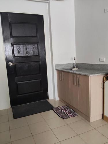 a black door in a kitchen with a counter and a sink at Zefe's Hideout in Lapu Lapu City