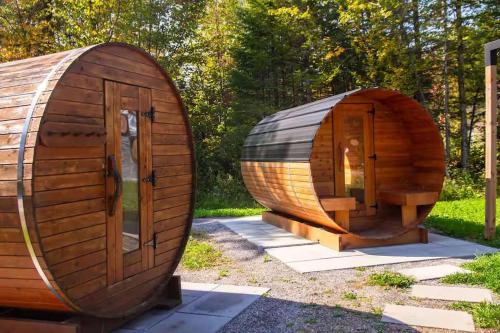 a circular wooden hobbit house in a garden at Pool Spa sauna & Pool Table - Beaulieu 110 in Pont-Rouge