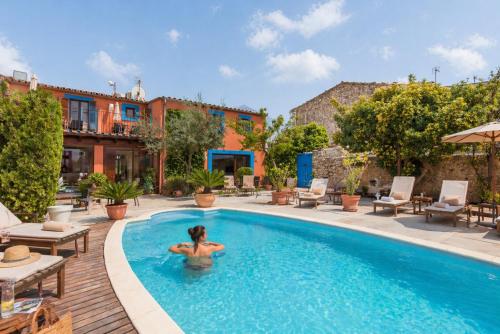 a woman in the pool at a hotel at Hotel Moscari Nature & Wellness by CheelHotels in Moscari