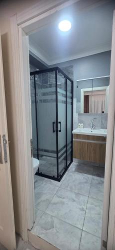 a bathroom with a shower and a tub and a sink at Blue Amedist Hotel in Istanbul
