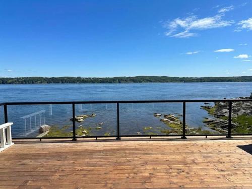 a view of a body of water from a pier at View Spa and St-Lawrence River - The DG Chalet in Sainte-Petronille