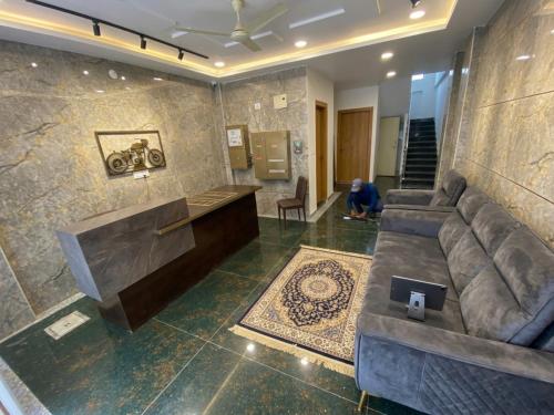 a living room with a couch and a table at Hotel HiCity Comfort Near DLF Cyber City & AIG Hospital in Hyderabad