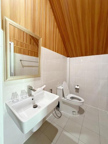 a bathroom with a sink and a toilet at Ther lay beach resort in Sikao