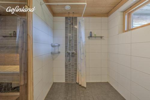 a bathroom with a shower with a glass door at Holiday Home Tattimetsä in Sysmä