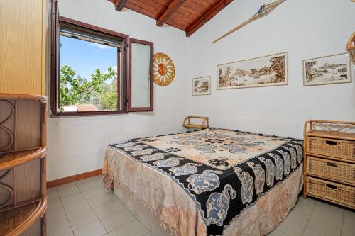 a bedroom with a bed and a window at Casa Gianpiero San Teodoro in San Teodoro