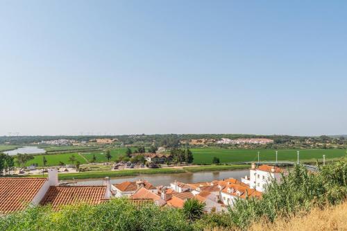 a view of a town with houses and a river at GuestReady - Enchanting retreat in Alcácer do Sal in Alcácer do Sal