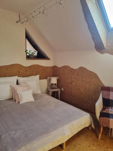 a bedroom with a bed and a window at Bámbi Apartman in Harsány