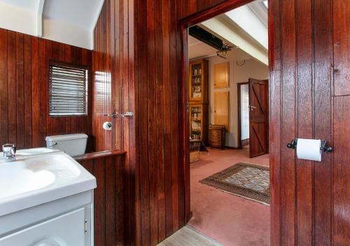 a bathroom with a sink and a toilet at Waterkloof Apartments in Pretoria