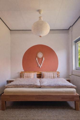a bedroom with a bed with a large wooden headboard at House of Flow in Pritzwalk