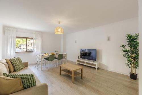 a living room with a couch and a table at 3BR Comfort & Convenience apt in central Massamá in Queluz