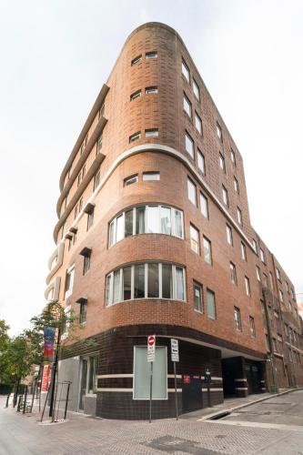 a large brick building on a city street at Spice Serviced Apartments in Sydney