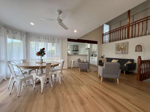 a dining room and living room with a table and chairs at Midtown Oasis - Sleeps 9 in Scarness