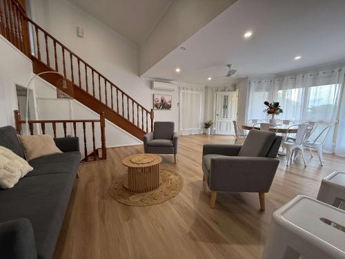 a living room with a couch and chairs and a table at Midtown Oasis - Sleeps 9 in Scarness