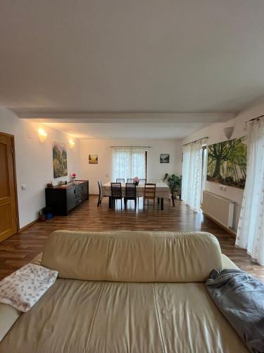 a large living room with a couch and a table at Casa di Panico in Buşteni