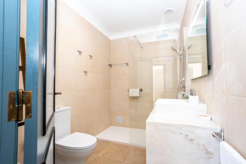 a bathroom with a toilet and a sink at Casas do Zé Zambujeira do Mar in Zambujeira do Mar