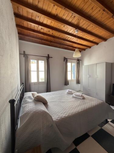 a bedroom with a large bed with two towels on it at Belou apartment in Mikonos