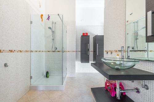 a bathroom with a glass sink and a shower at Casa Dudú in Quartucciu