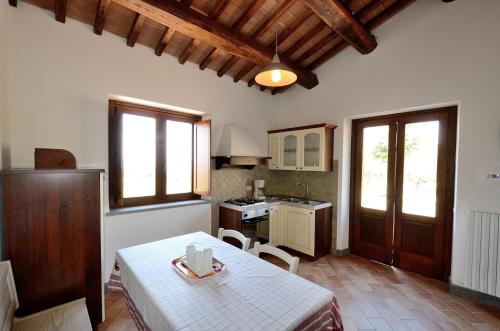 a kitchen with a table and a kitchen with a stove at Agriturismo Parco di Canuleio - con vista sul Lago in Bolsena