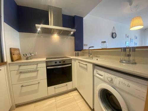 a kitchen with a washer and a washing machine at Apartament Sara in L'Eucaliptus
