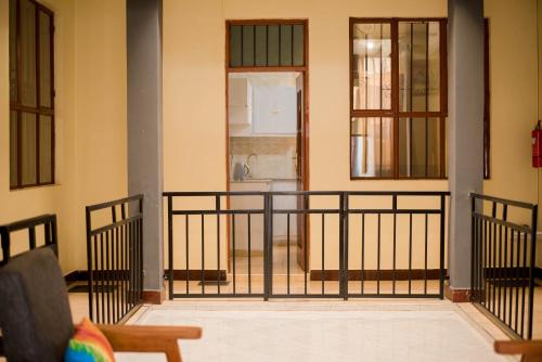 a room with a balcony with a door at Hecasa Apartments in Arusha