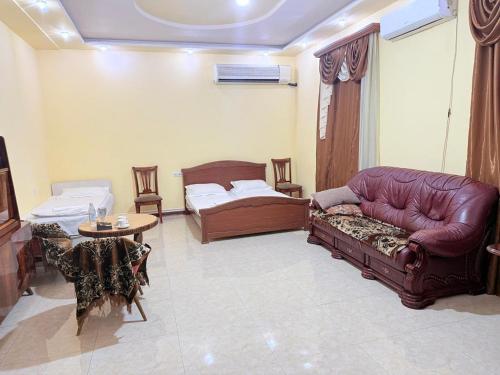 a living room with couches and a couch and a table at Garden EVN Airport 5 min from Airport in Pʼarakʼar