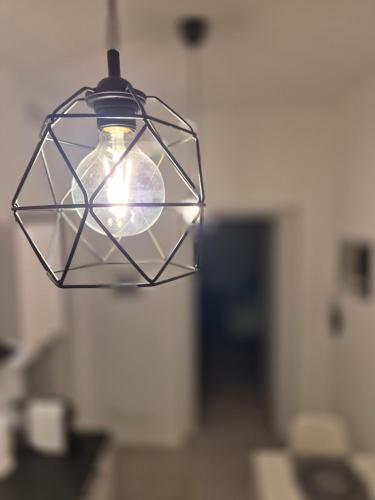 a light bulb hanging from a ceiling in a room at Casetta della Lupa in Cernusco sul Naviglio