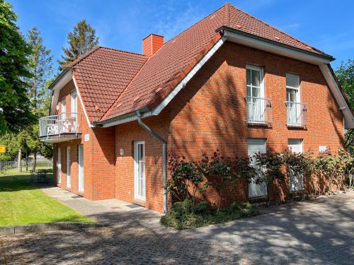 a red brick house with a red roof at Windwatt 2 in Zingst