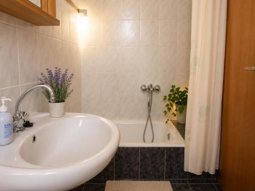 a bathroom with a sink and a bath tub at Argyroupolis Dimitris Rooms in Argyroupolis