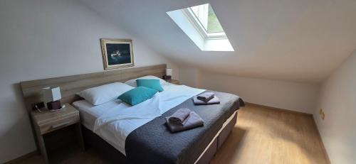 a bedroom with a bed with blue pillows and a window at Villa Kristina in Rovinj