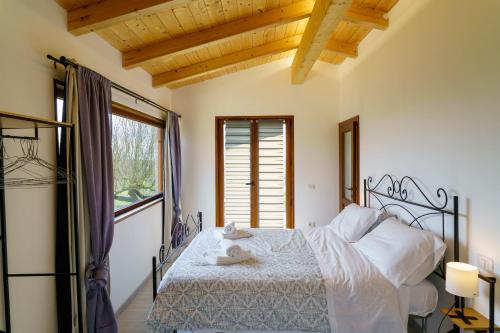 ein Schlafzimmer mit einem Bett und einem großen Fenster in der Unterkunft La Fortezza Alta in Avigliano