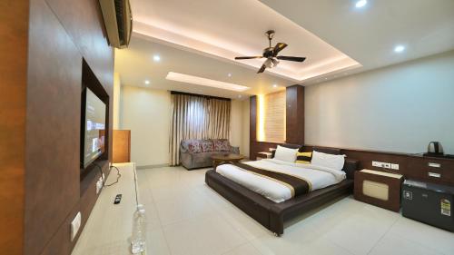 a bedroom with a bed and a flat screen tv at Rustam Villa Sector 39 in Gurgaon