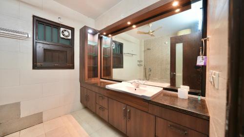 a bathroom with a sink and a mirror at Rustam Villa Sector 39 in Gurgaon