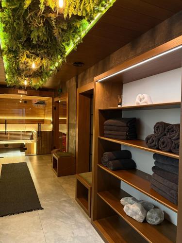 a bathroom with wooden shelves with towels at GreenHill Bachleda in Zakopane