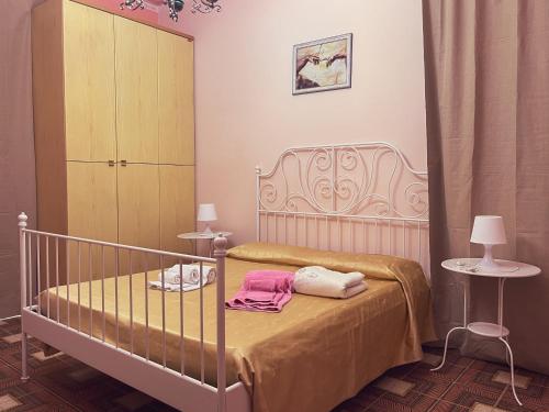 a bedroom with a crib with towels on it at Stella Marina in Giardini Naxos