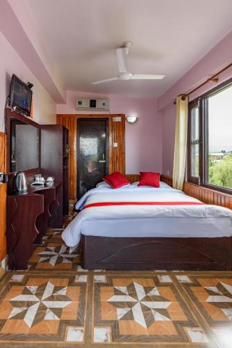 a bedroom with a large bed and a window at Hotel Monalisa Chitwan in Chitwan