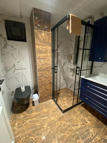 a bathroom with a shower and a toilet at Avullar Palace Hotel in Antalya
