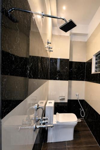 a bathroom with a toilet and a sink at Hotel The Galaxy in Dabok