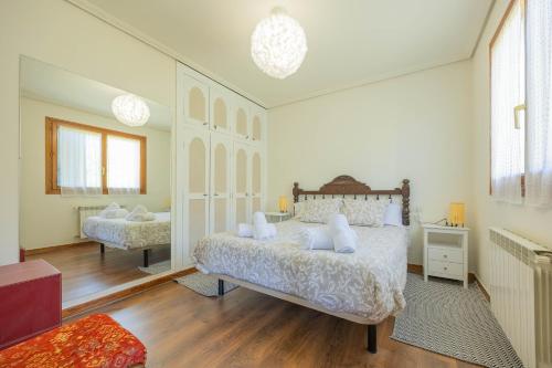a bedroom with two beds and a large window at Sea Garden in Mendiondo