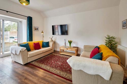 a living room with two couches and a table at Host & Stay - Beagle Barn in Withington