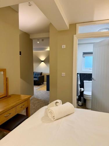 a bedroom with a bed with a towel on it at Grindal Studio Apartments - Newly Opened Luxury Accommodation in St Bees