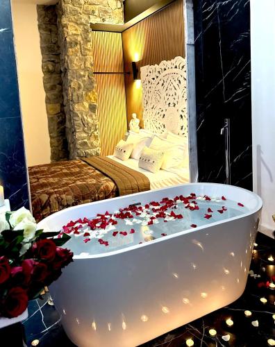 a bathroom with a tub and a bedroom with a bed at FORTUNA ORO Luxury Stay in Verona